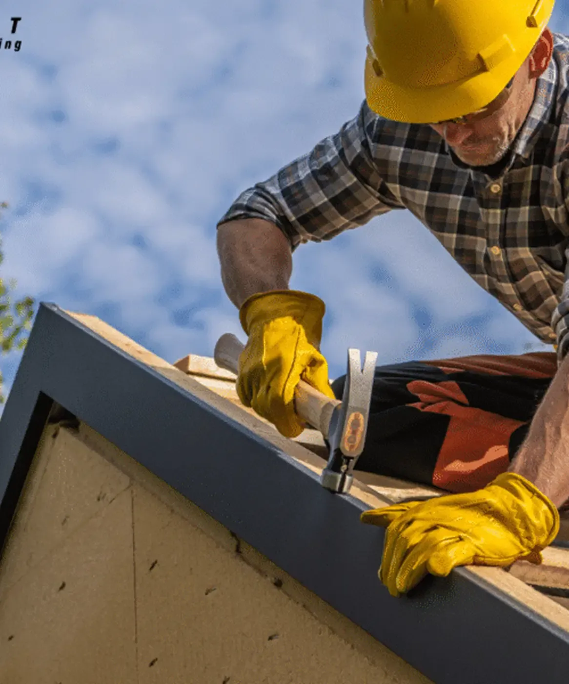A worker in yellow gloves and safety helmet installs roofing.